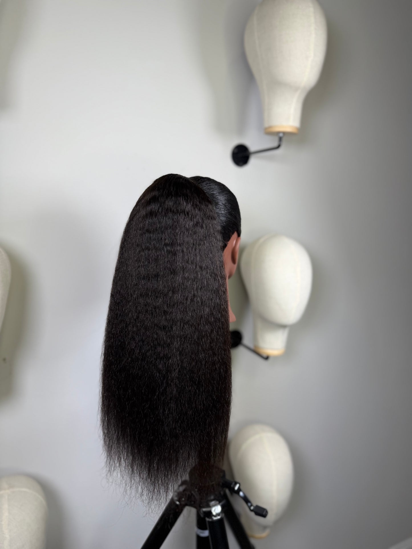 Black woman wearing natural texture drawstring ponytail – side view