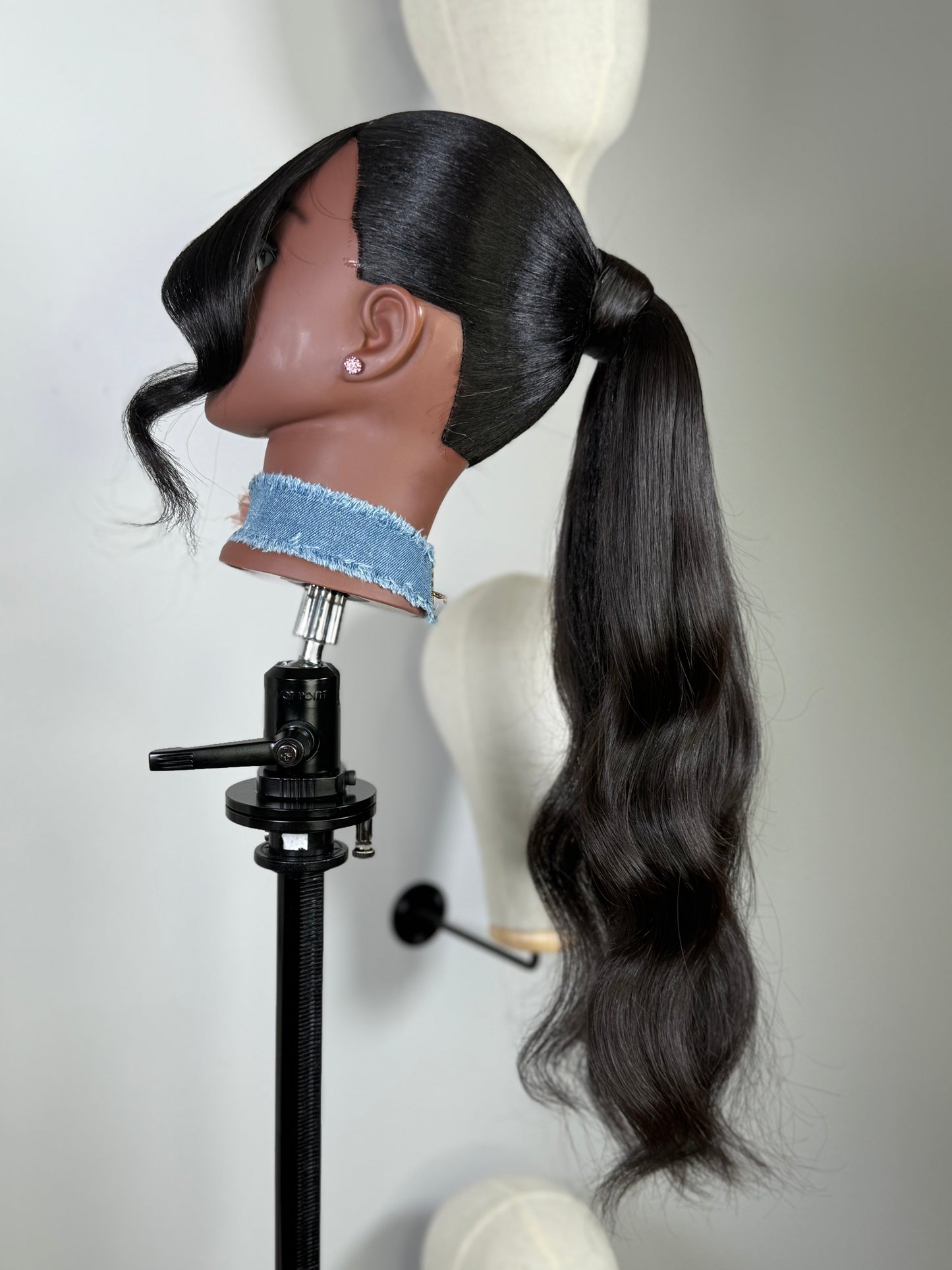 The Silken Sleek wrap-around ponytail styled with soft curls, from Wigs by Shanai’s Luxe Wraps Collection