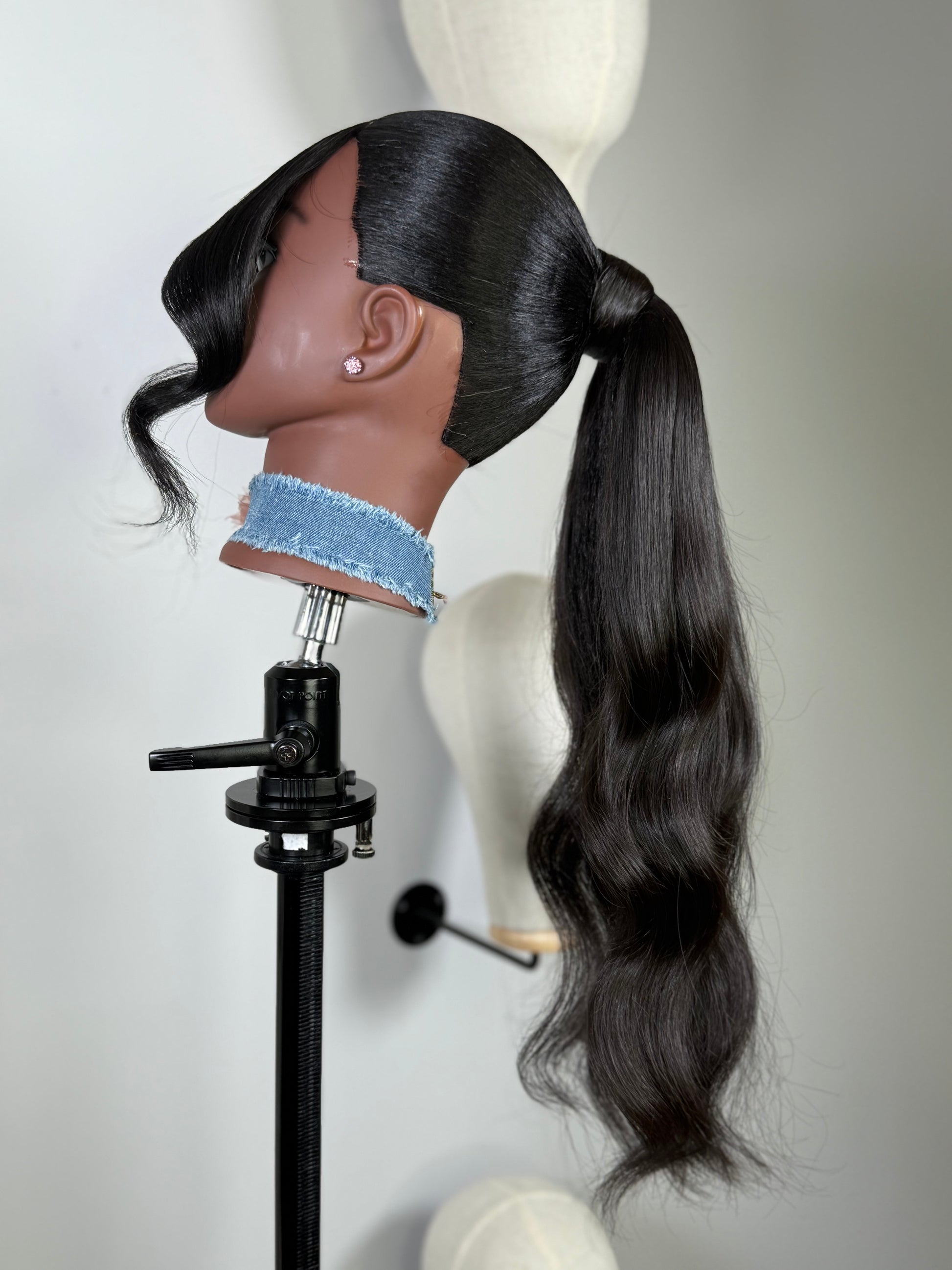 The Silken Sleek wrap-around ponytail styled with soft curls, from Wigs by Shanai’s Luxe Wraps Collection