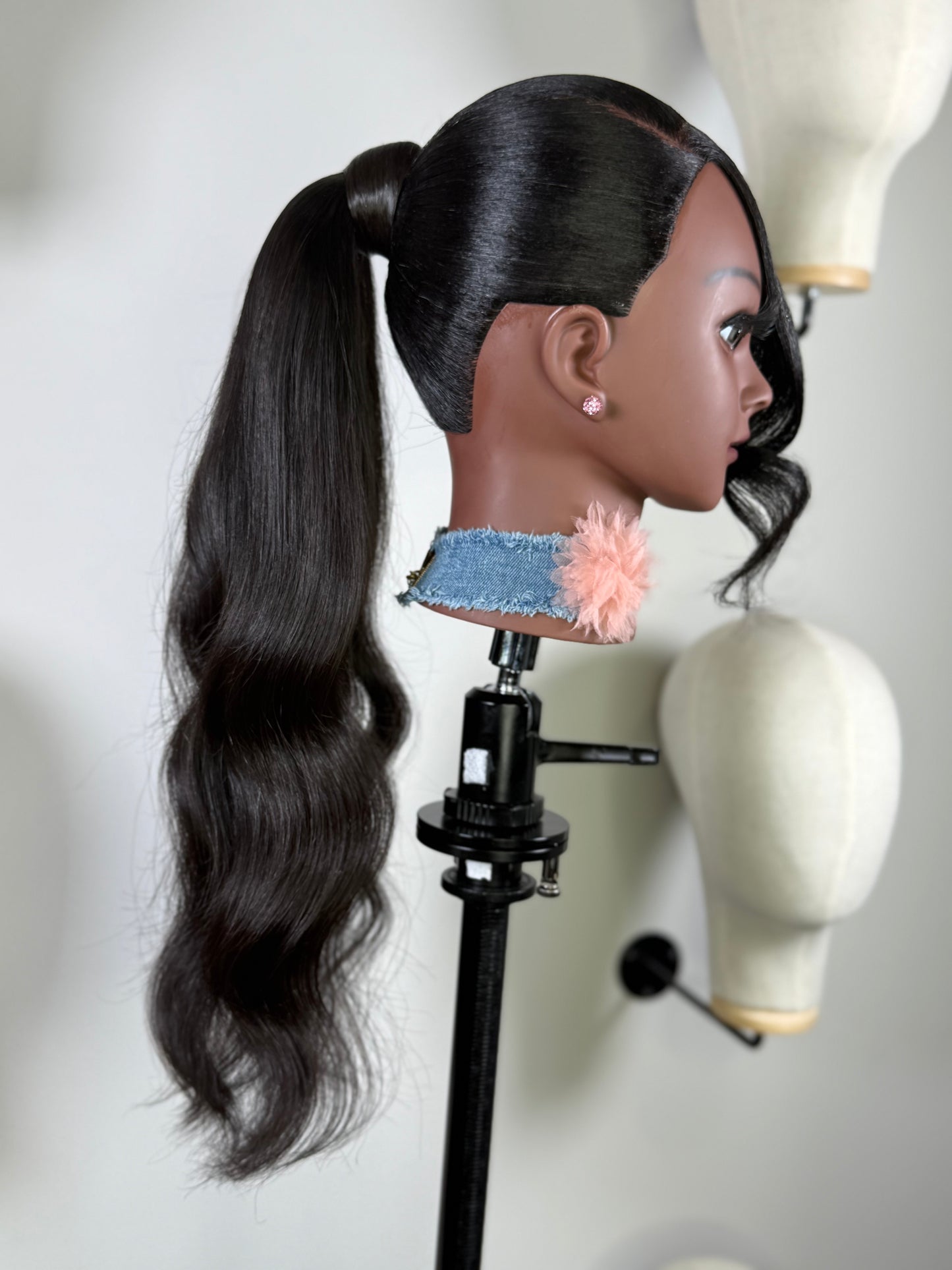 The Silken Sleek wrap-around ponytail styled with soft curls, from Wigs by Shanai’s Luxe Wraps Collection