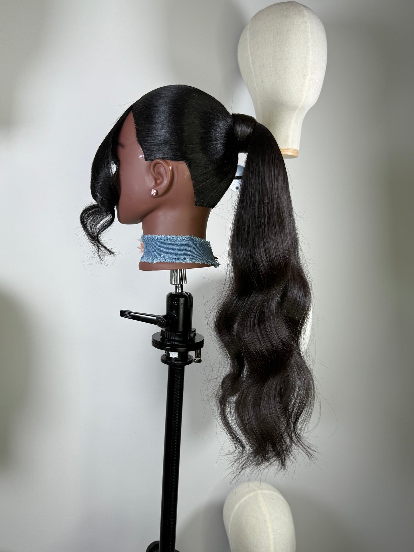 The Silken Sleek wrap-around ponytail styled with soft curls, from Wigs by Shanai’s Luxe Wraps Collection