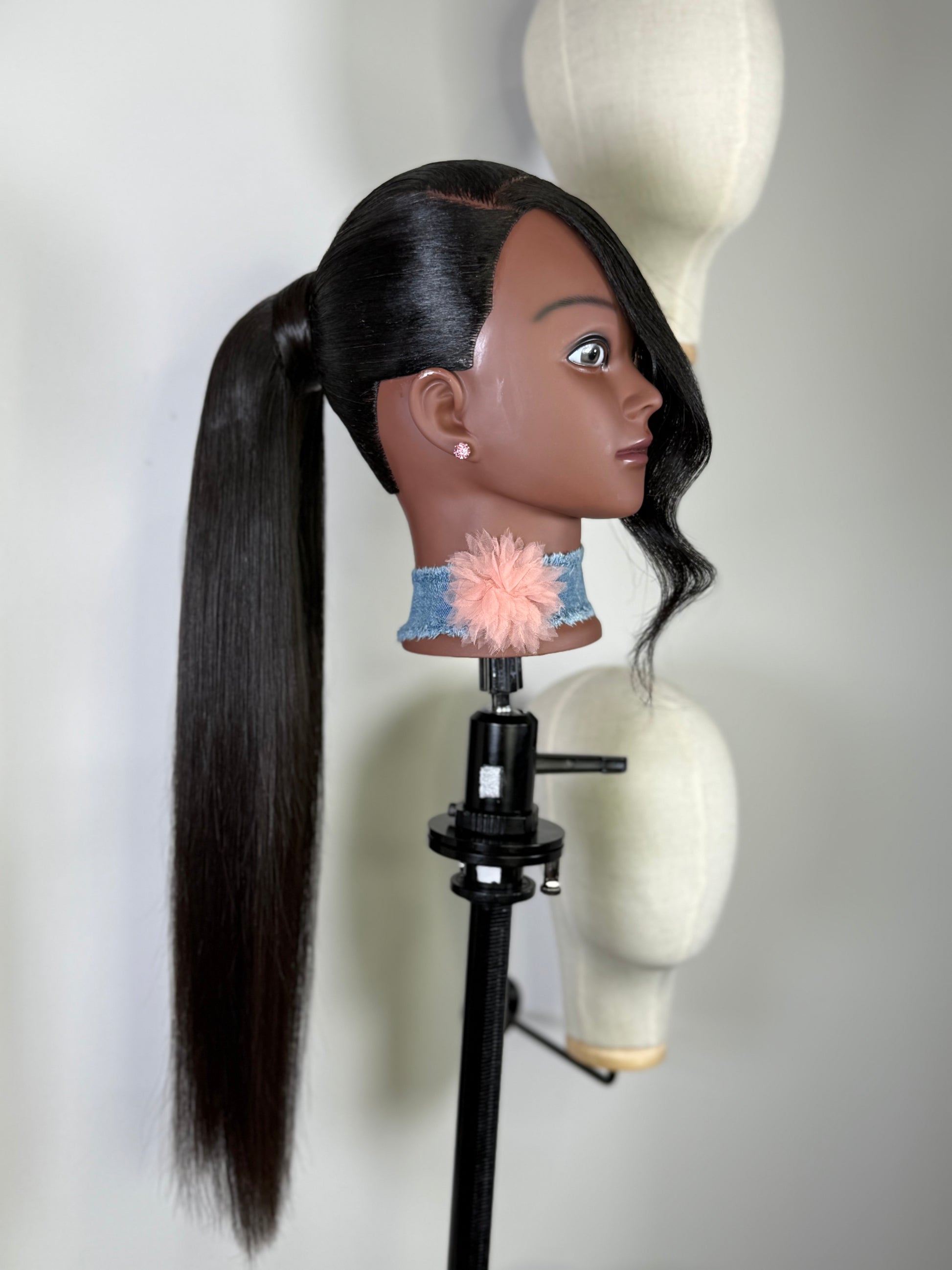 Close-up of Velvet Flow tie ponytail with sleek human hair.