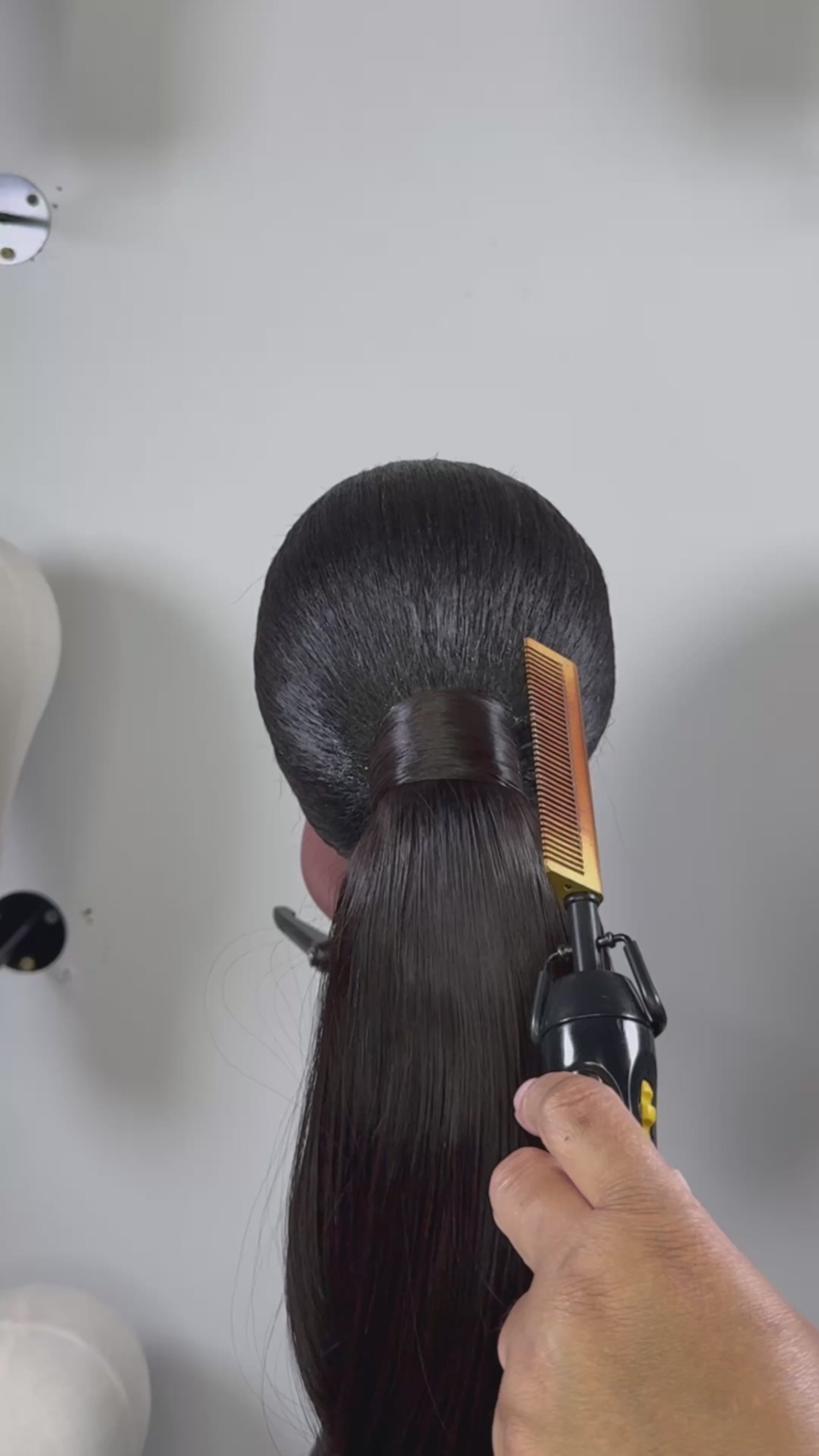 The Silken Sleek wrap-around ponytail styled with soft curls, from Wigs by Shanai’s Luxe Wraps Collection